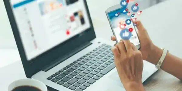 Books and phone with social media icons